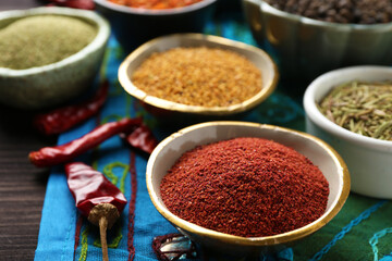 Different aromatic spices on wooden table, closeup