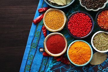 Different aromatic spices on wooden table, flat lay. Space for text