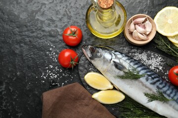 Seafood delicacies. Fresh raw mackerel and spices on black table, flat lay. Space for text