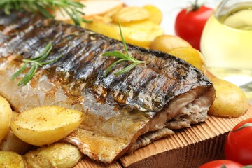 Tasty roasted mackerel with spices and vegetables on table, closeup. Homemade seafood dish