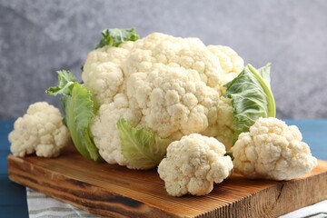 Raw cauliflower on blue wooden table, closeup