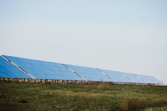 Array of photovoltaic panels in a field converting solar energy into electricity