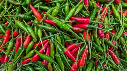 A vibrant mix of fresh green and red chili peppers, creating a spicy and colorful display.