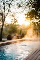 Steam Rising from Outdoor Heated Pool at Sunrise in a Tranquil Garden