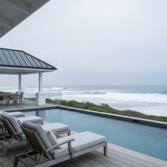 Fototapeta premium Coastal infinity pool overlooks crashing ocean waves on a cloudy day.