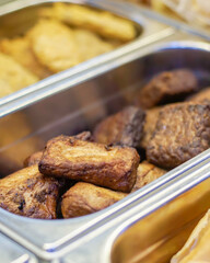 Traditional Indonesian braised tofu and tempeh, known as tahu dan tempe bacem, served in a food...