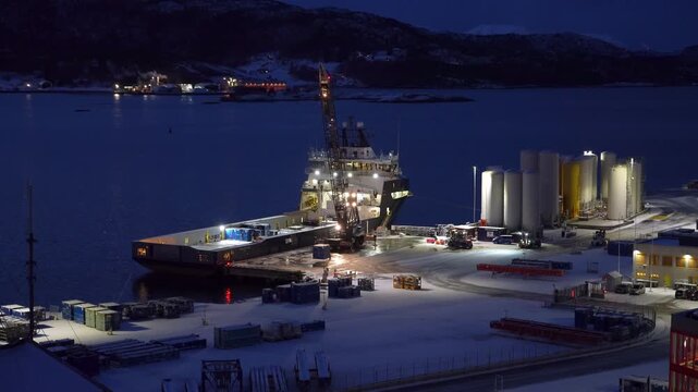 Mobile crane unloading containers from offshore vessel Troms Arcturus at Vestbase logistics terminal