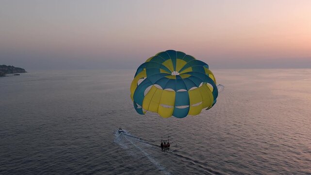 Parasailing at Sunset in Tropea Italy with Tourists Over the Sea