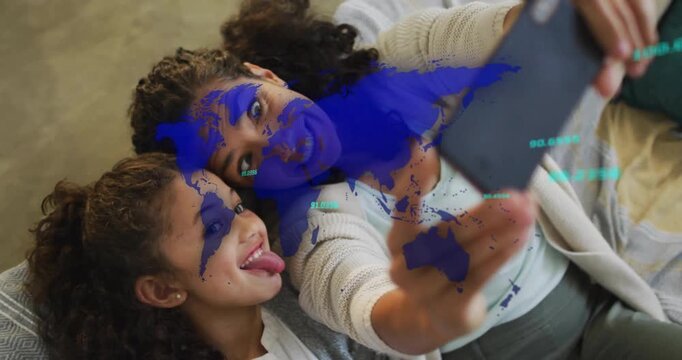 Mother lifting smartphone while daughter making playful faces for social media, world map animating