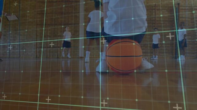 Coach conducting PE class balance drill, student kneeling on basketball balancing with grid overlay