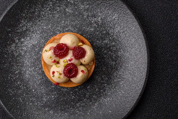 Sweet cake or tart round with cream and raspberries. Raspberry sweet tart