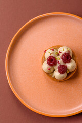 Sweet cake or tart round with cream and raspberries. Raspberry sweet tart