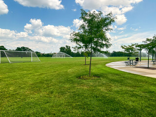 Sprinklers water grassy sports field at Forest Park in St. Louis, Missouri, USA. City park located in the heart of the city.