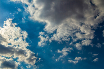 A beam of dark and light clouds and a partly cloudy sky.