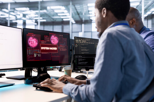 Group of engineering team coworkers in server hub working to protect equipment from hacker. Men in data center establishment in need of help from technicians to fix security breach alert