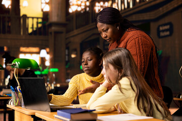 African american professor providing instruction to diverse girls during a private learning...
