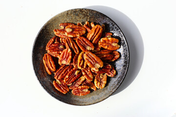 Delicious salted pecan nuts scattered.