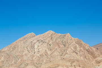 Rugged Hormozgan mountains rise beneath a flawless blue sky&mdash;an awe-inspiring blend of geology, desert serenity, and untouched natural beauty.