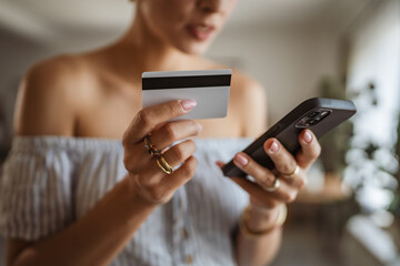 close up on woman use mobile phone and credit card for online shopping