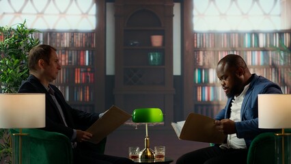 Multicultural top secret agents in a bureau reading confidential documents for evidence analysis,...