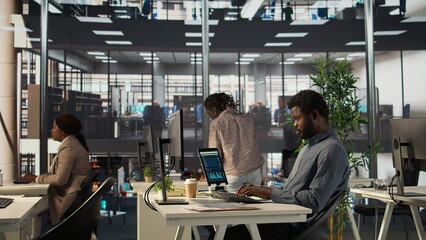 Analyst studying infographics and performance metrics for decision making, focused on project...