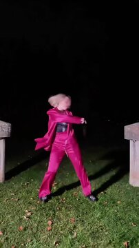 Professional dancer performing waacking at night