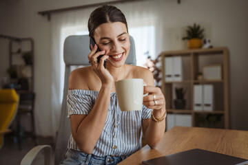 happy woman enjoy while drink coffee and talk on mobile phone at home