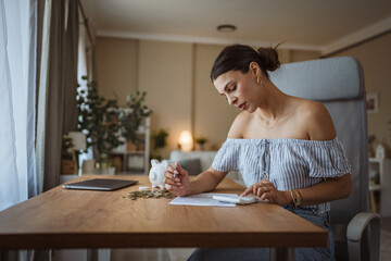 adult woman use calculate machine and review home bills and savings