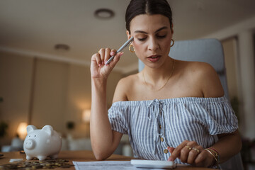 adult woman use calculate machine and review home bills and savings