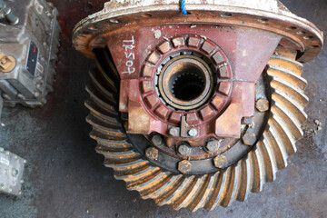 Dirty and broke Differential gear hub assembly need service on the floor.