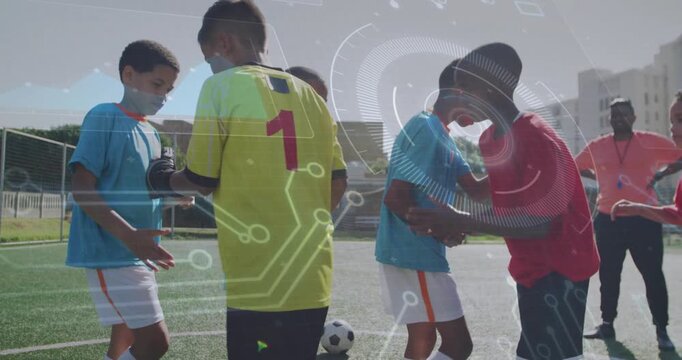 Goalkeeper stepping forward on turf initiating soccer sportsmanship greetings while coach observing