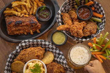 Fried Chicken, Chicken Wings and BBQ Ribs Plate with Beer 