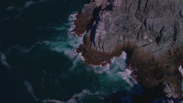 Aerial drone view of the ocean cliffs and rocky coastline of Punta Lobos in Baja California, showcasing the rugged beauty and dramatic landscape.