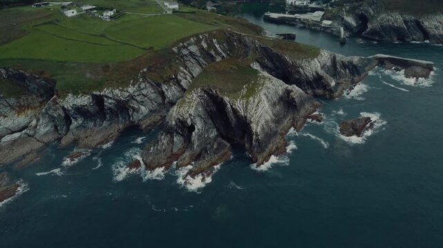 A breathtaking drone view of the rugged sea cliffs in Viav&eacute;lez, El Franco, Spain, showcasing the dramatic coastline and the deep blue ocean below.