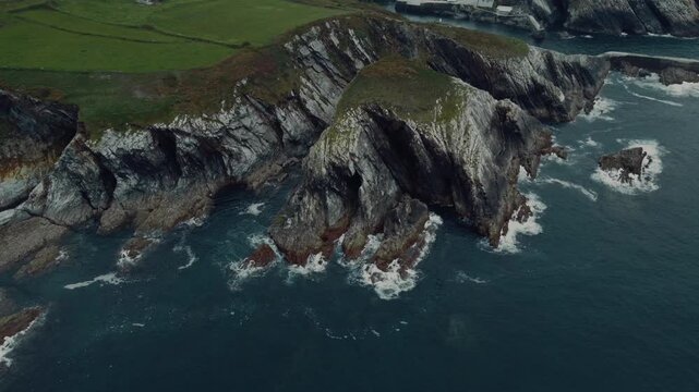 A breathtaking drone view of the rugged sea cliffs in Viav&eacute;lez, El Franco, Spain, showcasing the dramatic coastline and the deep blue ocean below.