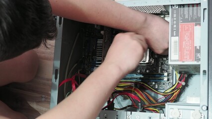 technician hold the screwdriver for repairing the laptop. computer hardware, repairing, upgrade and technology. professional technicial at workplace concentrated. focus on hands