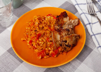 Appetizing pearl barley with cabbage served with fried brisket on platter