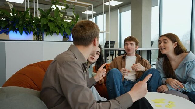 Teenagers playing guessing game with sticky notes on foreheads