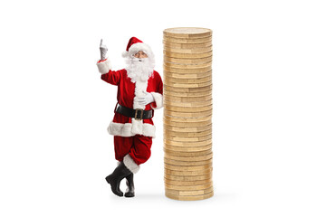 Santa claus leaning on a pile of coins and pointing up