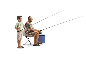 Full length profile shot of man and child with rods catching fish