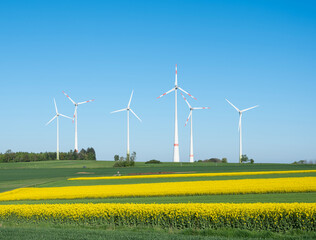 wind turbines under blue sky in german saarland in spring