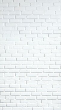 Full frame image of a clean and uniformly lit white painted brick wall, offering a versatile textured backdrop for various design applications.
