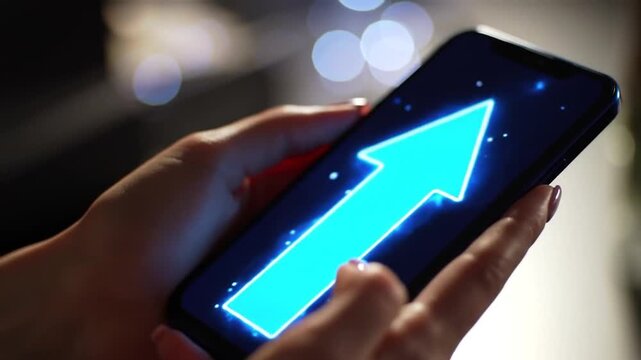Female Hands Holding Smartphone Displaying Glowing Upward Arrow on Screen with Blurred Background and Bokeh Lights