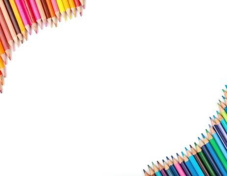 Rainbow collection of colored pencils arranged in corner frames on white background. Variety of shades, bright colors, perfect for education, creativity, art projects. Copy space available for text.