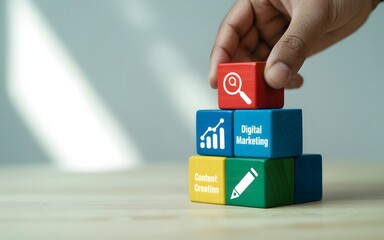 Hand stacking colorful blocks with digital marketing icons content creation