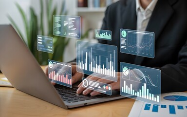 Person using laptop with holographic data charts and graphs business technology