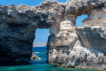 Ghemieri Window, a natural arch located on the east coast of Comino, not far from Santa Marija Bay