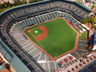Modern architecture of the stadium seen from above. Green lawn with baseball field markings. © kosoff