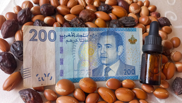 Moroccan 200 dirham banknote over Argan seeds