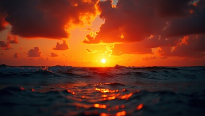 Vibrant orange and red sunset over ocean waves with sparkling water, symbolizing beauty and tranquility.